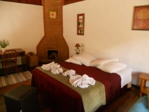 Banheira , Lareira e cama do chal&eacute; da Pousada Jardim das &Aacute;guas em Visconde de Mau&aacute;