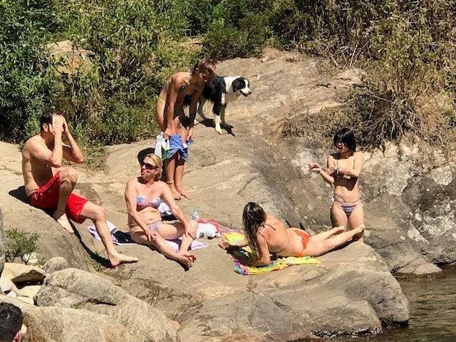 Pessoas tomando sol na cachoeira em Visconde de Mauá