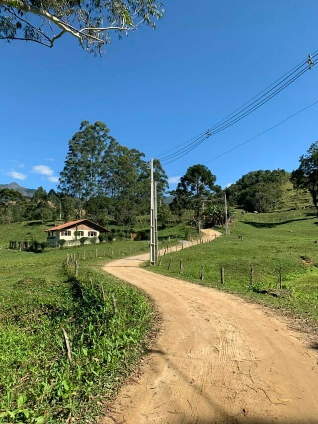 Estrada de cascalho serpenteando a mata de visconde de maua